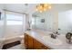 Clean bathroom with tub, vanity, and mirror at 15815 Muirfield Dr, Odessa, FL 33556