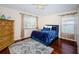 Bright bedroom with hardwood floors and a ceiling fan at 15815 Muirfield Dr, Odessa, FL 33556