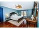 Main bedroom with hardwood floors, ceiling fan, and ensuite bathroom at 15815 Muirfield Dr, Odessa, FL 33556