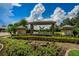 Gated community entrance with landscaping and a welcoming sign at 15815 Muirfield Dr, Odessa, FL 33556