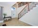Bright entryway with double doors and a wooden staircase at 15815 Muirfield Dr, Odessa, FL 33556