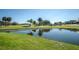 Golf course with a pond reflecting the clubhouse at 15815 Muirfield Dr, Odessa, FL 33556