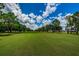 Picturesque view of a golf course with trees and fairways at 15815 Muirfield Dr, Odessa, FL 33556