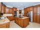 Gourmet kitchen with granite countertops and wooden cabinetry at 15815 Muirfield Dr, Odessa, FL 33556