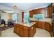 Bright kitchen features granite countertops, center island, and breakfast nook at 15815 Muirfield Dr, Odessa, FL 33556