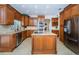 Spacious kitchen with granite island, stainless steel appliances, and ample cabinetry at 15815 Muirfield Dr, Odessa, FL 33556