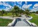 Landscaped walkway with stairs leading down to a pathway at 15815 Muirfield Dr, Odessa, FL 33556