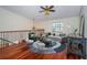 Spacious loft area with hardwood floors and a seating area at 15815 Muirfield Dr, Odessa, FL 33556