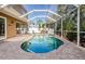 Inviting kidney-shaped pool with a screened enclosure at 15815 Muirfield Dr, Odessa, FL 33556