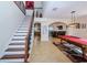 Elegant staircase with wrought iron railing overlooking the game room at 15815 Muirfield Dr, Odessa, FL 33556