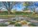 Landscaped backyard with unique chessboard pathway and garden at 15904 Wainwright Ct, Tampa, FL 33647