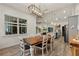 Bright dining room with farmhouse table and chandelier, open to kitchen at 1707 E Park Cir, Tampa, FL 33610