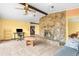 Living room with stone fireplace and wood beams at 18032 Dew Bloom Dr, Hudson, FL 34667