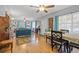 Living and dining area with teal sofas and a wooden dining table at 1901 10Th N St, St Petersburg, FL 33704