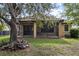 Landscaped backyard with screened patio and large tree at 20314 Chestnut Grove Dr, Tampa, FL 33647