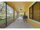 Relaxing screened porch with ceiling fan, offering outdoor seating at 20314 Chestnut Grove Dr, Tampa, FL 33647