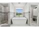 Modern bathroom with a large soaking tub, walk-in shower, and contemporary tile at 21 Crescent S Pl, St Petersburg, FL 33711