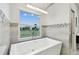 Relaxing bathroom with a modern soaking tub and large window at 21 Crescent S Pl, St Petersburg, FL 33711