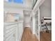 Light-filled hallway with hardwood floors and access to home office at 21 Crescent S Pl, St Petersburg, FL 33711