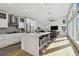Modern kitchen with white cabinets, large island, and stainless steel appliances at 21 Crescent S Pl, St Petersburg, FL 33711