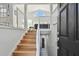 Elegant staircase with light wood and modern metal railing leading to the second floor at 21 Crescent S Pl, St Petersburg, FL 33711