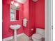 Pink bathroom with pedestal sink and toilet at 300 Beach Ne Dr # 704, St Petersburg, FL 33701