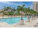 Inviting pool area with palm trees and lounge chairs at 300 Beach Ne Dr # 704, St Petersburg, FL 33701