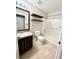 Neat bathroom with tub, toilet, and dark brown vanity at 30836 Temple Stand Ave, Wesley Chapel, FL 33543