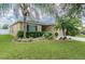 House exterior with lush landscaping and palm trees at 30836 Temple Stand Ave, Wesley Chapel, FL 33543