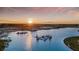 Aerial view of community Crystal Lagoon at sunset, featuring beach and water features at 32119 Spiceberry St, San Antonio, FL 33576