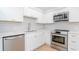 Modern white kitchen with stainless steel appliances and hexagon tile backsplash at 3301 Bayshore Blvd # 804D, Tampa, FL 33629