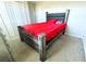 Bedroom with red bedding and double doors at 4208 Unbridled Song Dr, Ruskin, FL 33573