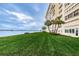 Building exterior with lush lawn and water views at 4775 Cove Cir # 1105, St Petersburg, FL 33708