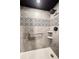 Walk-in shower with gray tile and patterned accent at 4775 Cove Cir # 1105, St Petersburg, FL 33708