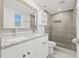 Updated bathroom with granite double vanity and grey tile shower at 509 Florida S Cir, Apollo Beach, FL 33572