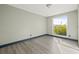 Bedroom with large window and wood-look floors at 509 Florida S Cir, Apollo Beach, FL 33572