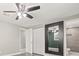 Bedroom with large mirror and ceiling fan at 509 Florida S Cir, Apollo Beach, FL 33572