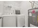 Bright laundry room, washer, dryer, shelving, and water heater at 509 Florida S Cir, Apollo Beach, FL 33572