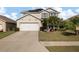 Two-story house with a large driveway and palm trees at 5119 11Th E St, Bradenton, FL 34203