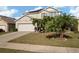 Two-story house with a large driveway and palm trees at 5119 11Th E St, Bradenton, FL 34203