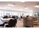 Bright and airy community room with tables, chairs, and a lounge area at 5876 21St N St # 3, St Petersburg, FL 33714