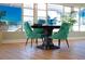 Elegant dining area with teal chairs and a dark wood table at 5876 21St N St # 3, St Petersburg, FL 33714