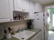 White cabinets, sink, and appliances in this kitchen at 5876 21St N St # 3, St Petersburg, FL 33714