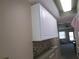 White cabinets and a tile backsplash in this kitchen area at 5876 21St N St # 3, St Petersburg, FL 33714
