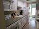 Well-equipped kitchen with white cabinets and appliances at 5876 21St N St # 3, St Petersburg, FL 33714
