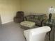 Living room with two armchairs and ottoman at 5876 21St N St # 3, St Petersburg, FL 33714