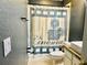 Bathroom with shower, toilet, and movie-themed shower curtain at 6047 Twin Bridges Dr, Zephyrhills, FL 33541