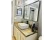 Modern bathroom with a sleek sink, wood-look vanity, and stylish mirror at 6047 Twin Bridges Dr, Zephyrhills, FL 33541