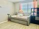 Charming bedroom with a daybed, plenty of storage and natural light at 6047 Twin Bridges Dr, Zephyrhills, FL 33541