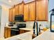 Modern kitchen with wood cabinets and stainless steel appliances at 6047 Twin Bridges Dr, Zephyrhills, FL 33541